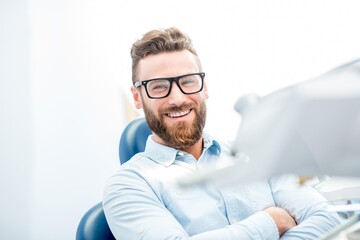 dental, smile, patient, dentist, male, happy, chair, man, office, health, care, clinic, medical, portrait, visit, hygiene, white, people, dentistry, doctor, healthy, sitting, caucasian, handsome, healthcare, perfect, face, smiling, medicine, guy, positive, toothcare, shirt, elegant, beard, eyeglasses, businessman